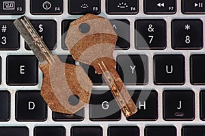 Old and rusty keys on laptop keyboard, computer security and password concept