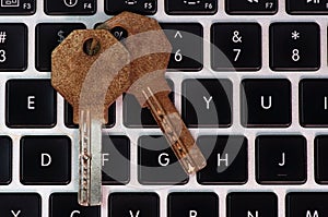 Old and rusty keys on laptop keyboard, computer security and password concept