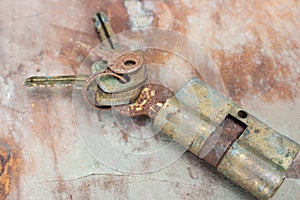 Old rusty keys in lock. Vintage door padlock with keys. Antique keys on weathered background with copy space. Security and safety.