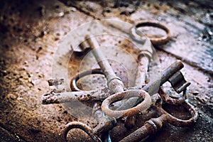 Old rusty keys on a wooden table