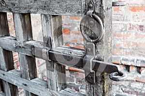 Old and rusty latch and handle on wooden door