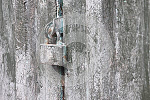 An old rusty lock on the door of an abandoned barn.