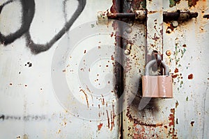 Old rusty lock on grunge metal door