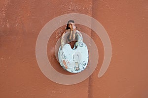 An old rusty lock on an iron door