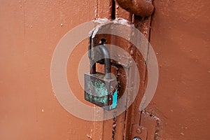 An old rusty lock on an iron door