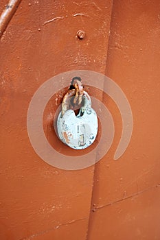 An old rusty lock on an iron door