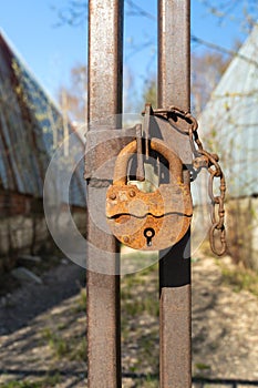 Old rusty lock on a metal gate