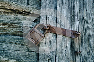 Old rusty lock on an old wooden door