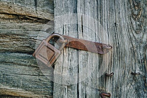 Old rusty lock on an old wooden door