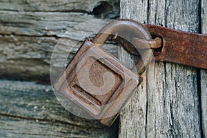 Old rusty lock on an old wooden door