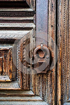 Old rusty lock on an old wooden door close-up. Vertical frame