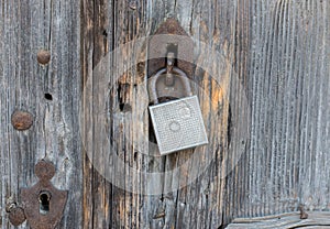 Old rusty lock on a wooden door