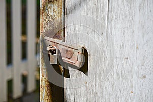 Old rusty lock on the wooden gate