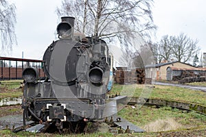 Old rusty locomotive of the narrow gauge railway. Place of stationing of old steam locomotives
