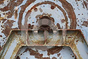 Old rusty machine part with nut and bolt