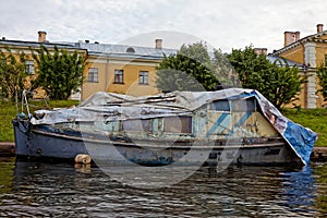 Old rusty machinery boat on the river dock