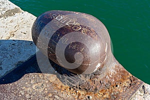 old and rusty maritime dock bollard
