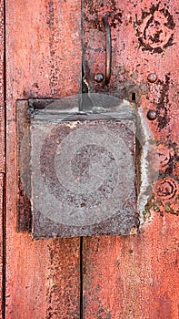 Old rusty metal background with a box lock. The vertical frame.