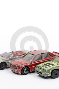 Old and rusty metal car toys isolated above white background