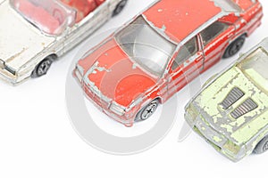 Old and rusty metal car toys isolated above white background