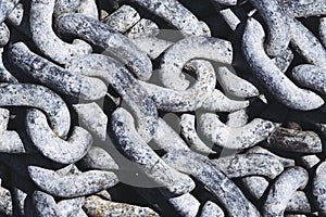 Old rusty metal chains with large links in a port photo
