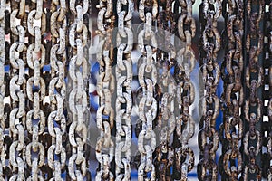 Old rusty metal chains with large links in a port