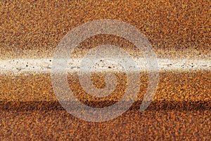 Old rusty metal corrugated sheet with iron oxides