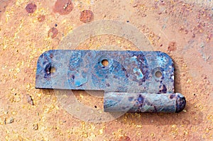 Old rusty metal door hinge. Close-up. Isolated on metall background