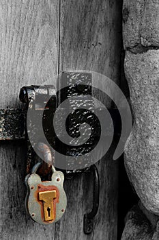 Old rusty metal door latch and padlock