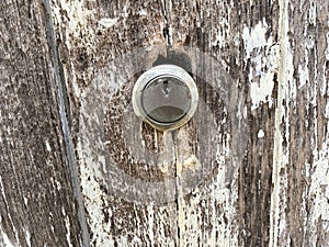 Old rusty metal door on a wooden background