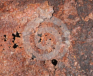 Old rusty metal exfoliating sheet with holes, texture