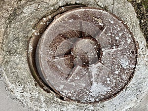 Old rusty metal hatch on concrete