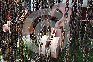 Old rusty metal hoist chain and pulley