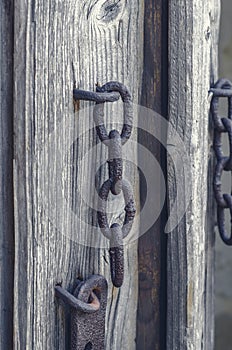 Old rusty metal latch on wooden door