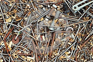 Old rusty metal nails bolts nuts and screws as background