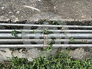 old rusty metal pipe on cement wall