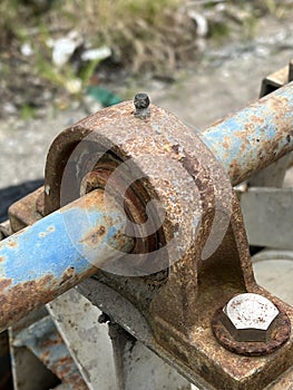 Old rusty metal pipe with a chain