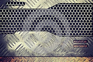 Old rusty metal plate over comb grid or grille background