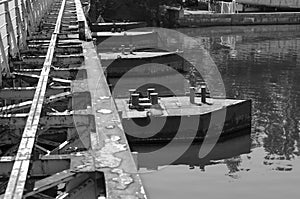 Old rusty metal pontoon bridge over the river