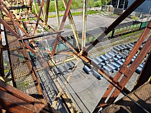 Old rusty metal structures. Old gantry crane. Descent down, passage.