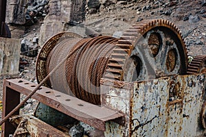 Old rusty metal Winch with coiled rope