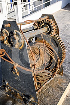 Old rusty metal Winch with coiled rope. The Port Of La Caletta. Tenerife, Canary Islands, Spain