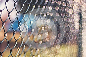 Old rusty metal wire mesh outdoor defocus background, blurred texture, soft focus vintage lens