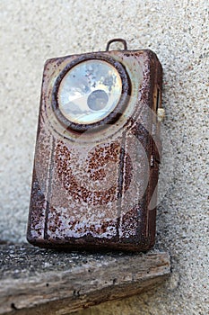 Old, rusty military pocket flashlight with preserved switch
