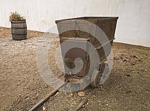 An old and rusty mining cart on rails