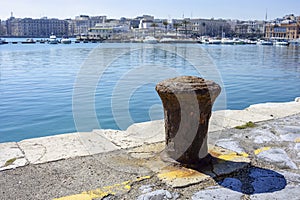 Old and rusty mooring bollard