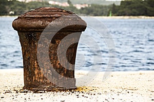 Old and rusty mooring post