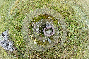 Old and rusty mooring ring for ships fixing.