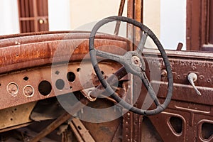 Old rusty motor car steering wheel in a scrap yard