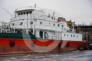 Old rusty motor ship. Volgograd. Krasnoarmeysky Zaton, wintering of ships on a frozen river.